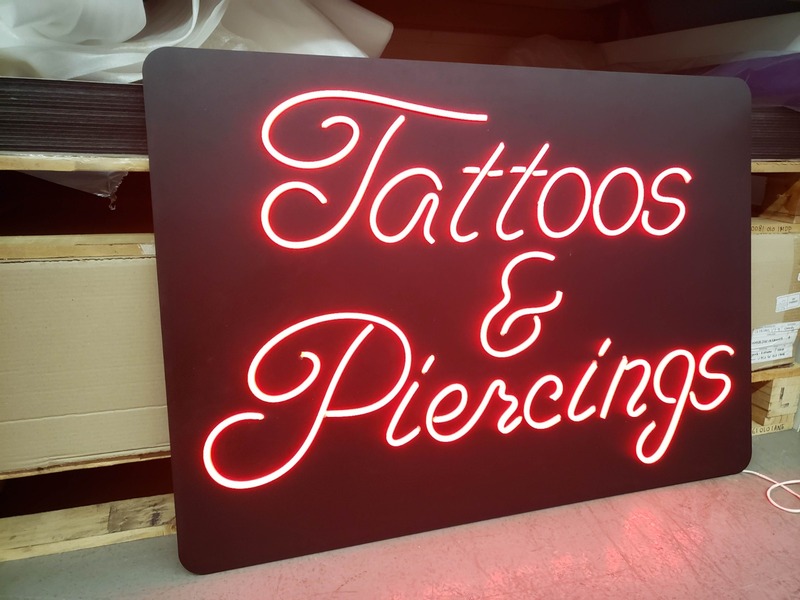 Custom red neon sign for a tattoo and piercing studio
