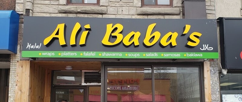 Illuminated storefront sign for Ali Baba's Halal in Cambridge