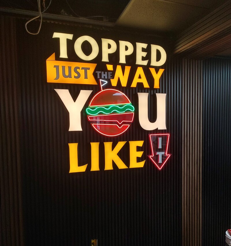 Restaurant interior mixed LED and neon wall sign installation